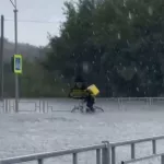 По колеса в воде, но по графику: барнаульский курьер на велосипеде борется со стихией