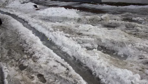 Барнаульские дорожники выгребают воду с затопленной улицы